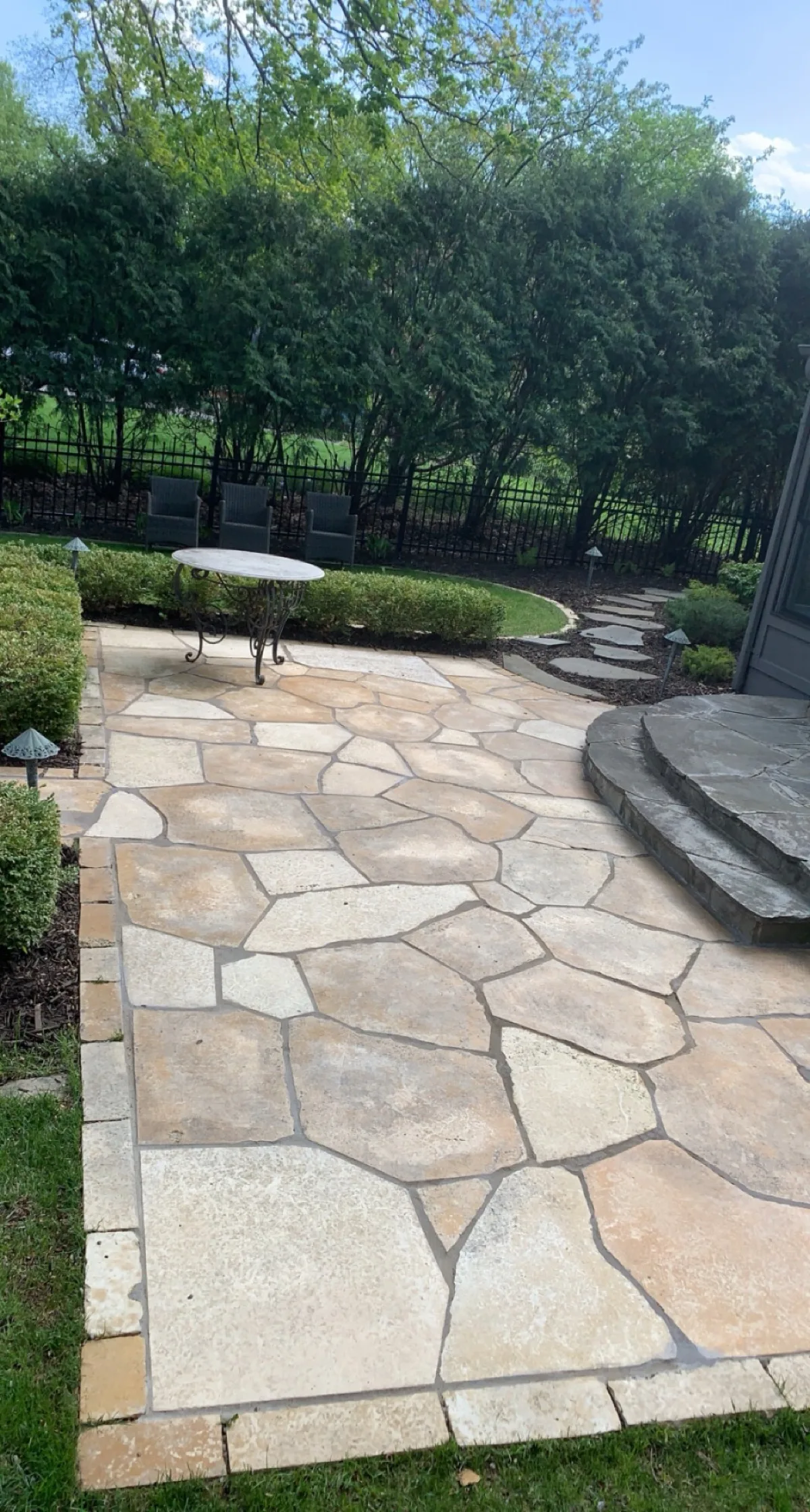 Natural flagstone patio with fitted stone steps and landscape beds